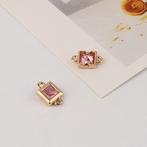 Detail of pink square zircon stone set in gold-plated copper connector for DIY jewelry