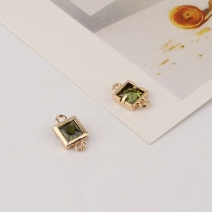 Macro shot of gold-plated square green zircon connectors for DIY jewelry making
