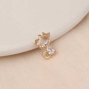 Detailed view of a gold-plated cat charm with sparkling cubic zirconia for DIY jewelry