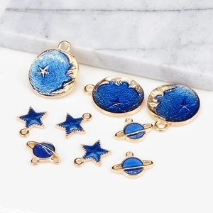 Star and planet enamel charm set with moon and celestial patterns in blue and gold