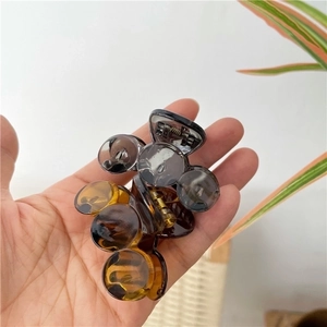 Set of two transparent gray and amber hair claws made of resin with gold metal springs