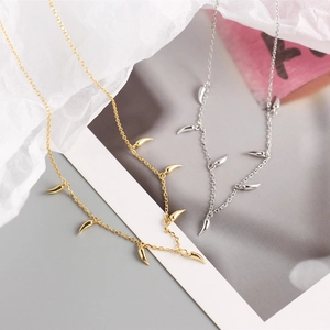 Detailed view of layered S925 sterling silver necklaces with chili-style charms