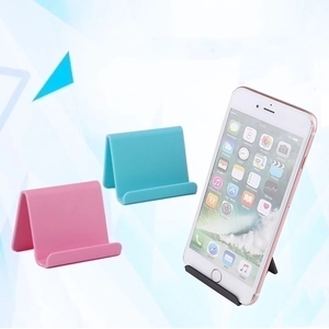 Universal folding desktop phone stands in pink, blue, and black with a triangular design