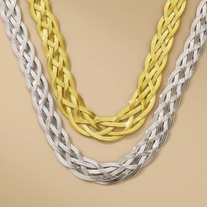 Detailed view of woven snake chain necklaces in gold and silver stainless steel finishes