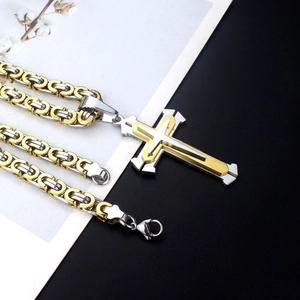 Two-tone gold and silver cross pendant necklace with Byzantine chain on professional backdrop