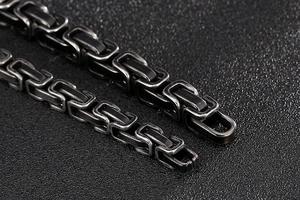 Macro detail of men's vintage stainless steel Byzantine chain with oxidized finish