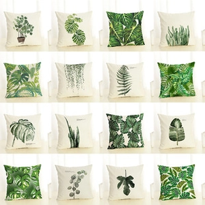 Grid display of square pillow covers with various green botanical leaf patterns