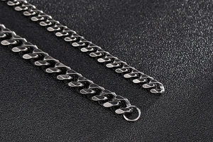 Close-up of vintage cuban link chain showing industrial antique silver finish and texture