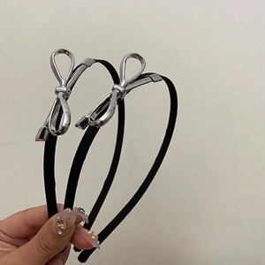 Minimalist black headband with elegant silver metal bow hair accessory for women