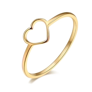 Close-up of heart-shaped hollow design on polished gold stainless steel ring