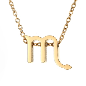 Detailed macro view of golden Scorpio zodiac symbol pendant on a fine ring chain necklace