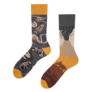 Asymmetrical jacquard crew socks featuring fossil and volcano patterns on white background