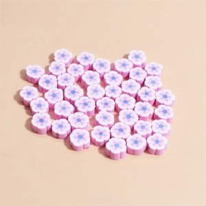 Macro detail of 10mm flower polymer clay beads in pink and blue for DIY jewelry making