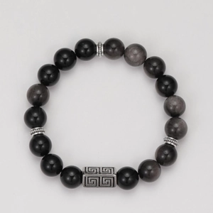 Detail of obsidian beaded bracelet with silver metal spacers and rectangular charm