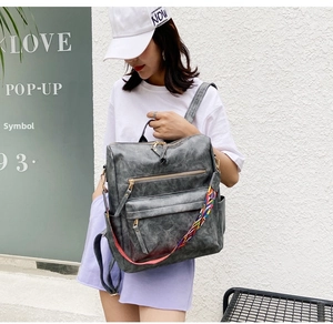 Détail du sac à dos vintage en cuir PU gris avec bandoulière brodée de style ethnique