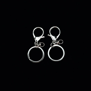 Close-up of polished silver lobster clasps with flat metal keyrings for DIY keychains