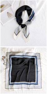Close-up of elegant black satin square scarf with geometric blue and grey line patterns