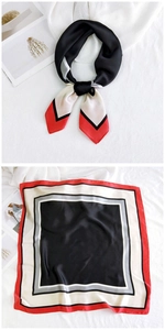 Detail of elegant geometric silk square scarf with red and black color block patterns