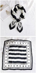 Detail of square silk scarf featuring black and white stripes with star patterns