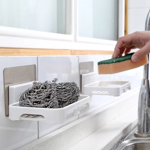 Wall-mounted white plastic sponge holder with drainage grid for kitchen sink organization