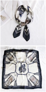 Detail of vintage square silk scarf featuring horse carriage prints and retro patterns