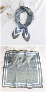 Detail of blue square silk scarf with golden chain horsebit print and elegant borders