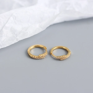 Detail view of gold S925 silver hoop earrings with micro-set cubic zirconia stones