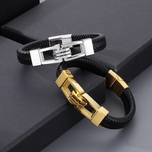 Detail of men's woven leather bracelets with silver and gold stainless steel clasps