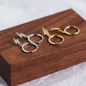 Detail of S925 sterling silver lightning bolt hoop earrings in gold and silver finishes