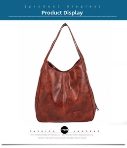 Detailed macro view of deep red-brown leather hobo bag with grainy lychee texture