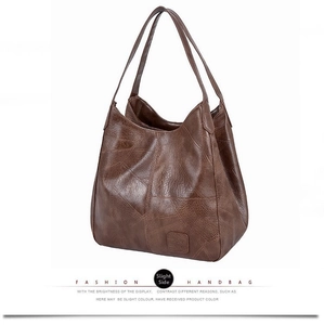 Detail view of coffee brown vintage tote bag with retro stitched texture and large handles
