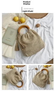 Detail of light khaki woven straw bag with round wooden handle and tassel accent