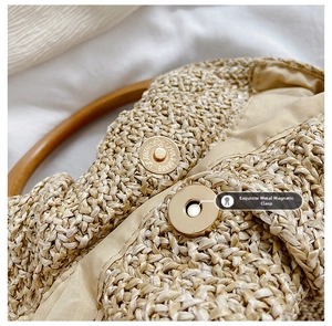 Detailed view of woven handbag featuring a golden magnetic clasp and round wooden handle