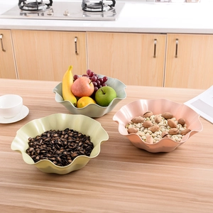 Three-piece ruffle edge plastic fruit bowls in pastel green, pink, and cream yellow