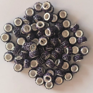 Close-up of sparkling purple pave crystal beads with silver eyelet for jewelry making