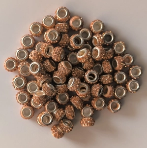 Macro shot of 7x12mm peach rhinestone beads with large silver-tone metal holes for jewelry