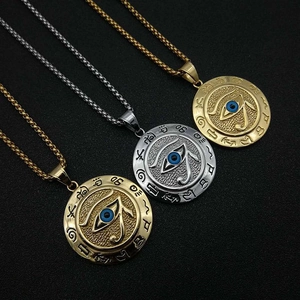 Detail of Eye of Horus pendants in gold and silver finish with blue enamel eye detail