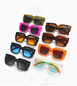 Detail showing oversized square frame sunglasses in multiple vibrant colors with metal rivets