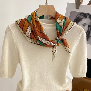 Elegant square silk scarf with geometric chain pattern on white knitwear for women