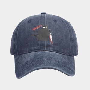 Detail of a washed blue cotton baseball cap featuring a funny cartoon cat print