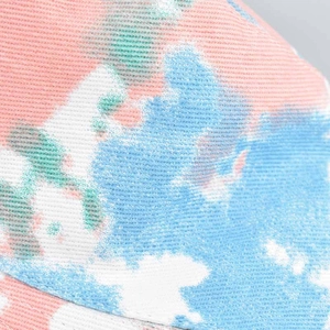 Macro view of durable twill cotton fabric with colorful tie-dye patterns in blue and pink