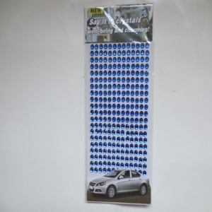 Detail of blue oval crystal stickers sheet in clear plastic packaging with a paper header
