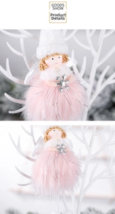Detail of plush Christmas angel ornament with pink faux fur dress and silver snowflake
