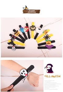 Detail of Halloween slap bracelets featuring pumpkin, ghost and bat elements for party decor