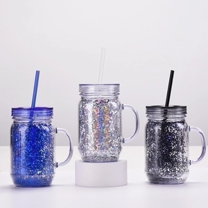 Three double-wall glitter plastic mason jars with handles and straws in blue silver black