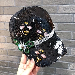 Detail of sequins baseball cap with butterfly and honeybee rhinestone decorations
