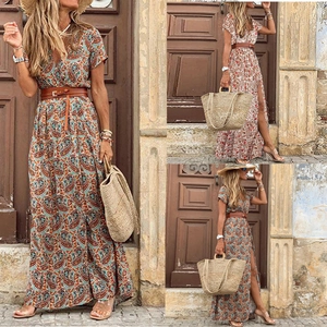 Bohemian floral V-neck maxi dress with short sleeves and brown waist belt on stone backdrop