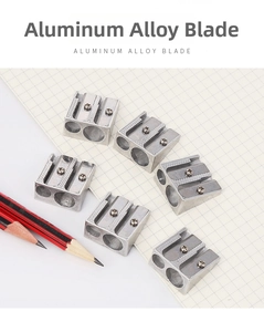 Top view of dual-hole aluminum alloy sharpeners with non-slip texture on grid paper