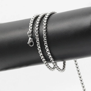 Minimalist silver stainless steel square chain necklace with lobster clasp on a display