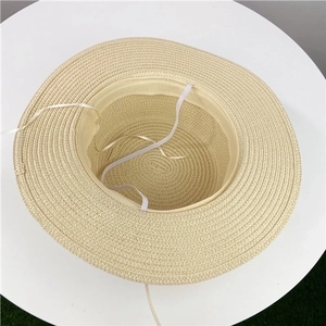 Classic beige woven straw sun hat for women featuring a wide brim and adjustable chin strap